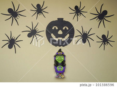 Cute witch in monster costume. Scary Halloween figurine stand on a light background close-up Cute witch in monster costume. Scary Halloween figurine stand on a light background close-up 101386596