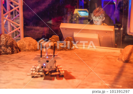 The boy controls the toy rover on Mars. Flight to Mars concept 101391297