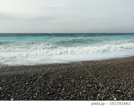 Pebble beach of Nice, France with azure waves of mediterranean sea 101391662