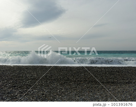 Pebble beach of Nice, France with azure waves of mediterranean sea 101391676