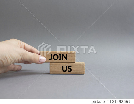 Join us symbol. Concept word Join us on wooden blocks. Beautiful grey background. Businessman hand. Business and Join us concept. Copy space Join us symbol. Concept word Join us on wooden blocks. Beautiful grey background. Businessman hand. Business and Join us concept. Copy space 101392667