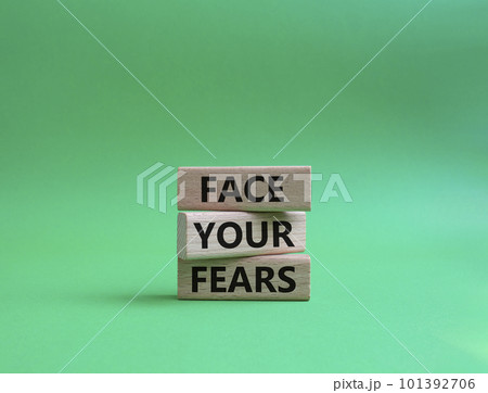 Face your Fears symbol. Wooden blocks with words Face your Fears. Beautiful green background. Business and Face your Fears. Copy space. 101392706
