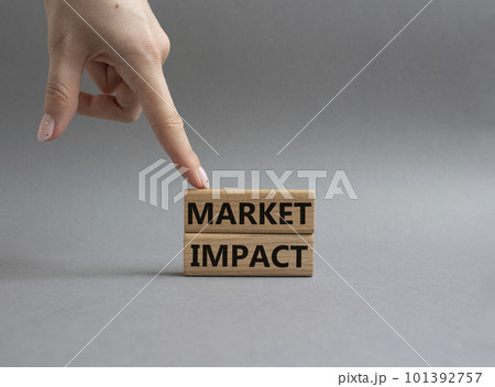Market impact. Concept word Market impact on wooden cubes. Beautiful grey background. Businessman hand. Business and Market impact concept. Copy space. Market impact. Concept word Market impact on wooden cubes. Beautiful grey background. Businessman hand. Business and Market impact concept. Copy space. 101392757