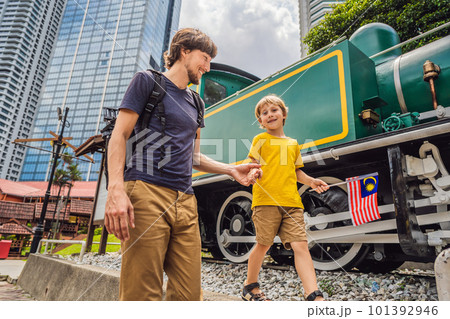 Father and son travelers in malaysia with malaysia flag celebrating the Malaysia independence day and Malaysia day. Travel to Malaysia concept 101392946