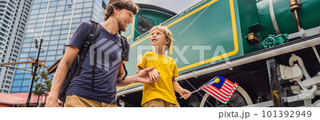 Father and son travelers in malaysia with malaysia flag celebrating the Malaysia independence day and Malaysia day. Travel to Malaysia concept BANNER, LONG FORMAT Father and son travelers in malaysia with malaysia flag celebrating the Malaysia independence day and Malaysia day. Travel to Malaysia concept BANNER, LONG FORMAT 101392949