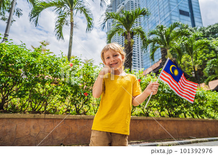 Boy travels in malaysia with malaysia flag celebrating the Malaysia independence day and Malaysia day. Travel to Malaysia concept Boy travels in malaysia with malaysia flag celebrating the Malaysia independence day and Malaysia day. Travel to Malaysia concept 101392976