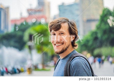 Man tourist on background of fountain on the lake at night, near by Twin Towers with city on background. Kuala Lumpur, Malaysia 101393314