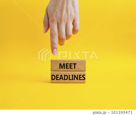 Meet Deadlines symbol. Concept word Meet Deadlines on wooden blocks. Beautiful blue background. Businessman hand. Business and Meet Deadlines concept. Copy space Meet Deadlines symbol. Concept word Meet Deadlines on wooden blocks. Beautiful blue background. Businessman hand. Business and Meet Deadlines concept. Copy space 101393471