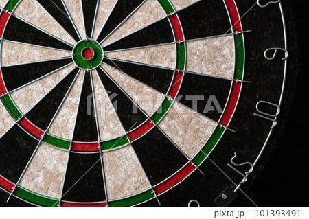 New classic professional sisal dart board on black wooden background. Close up. New classic professional sisal dart board on black wooden background. Close up. 101393491