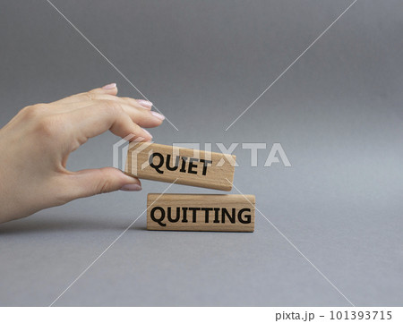 Quiet quitting symbol. Concept word Quiet quitting on wooden blocks. Beautiful grey background. Businessman hand. Business and Quiet quitting concept. Copy space. Quiet quitting symbol. Concept word Quiet quitting on wooden blocks. Beautiful grey background. Businessman hand. Business and Quiet quitting concept. Copy space. 101393715