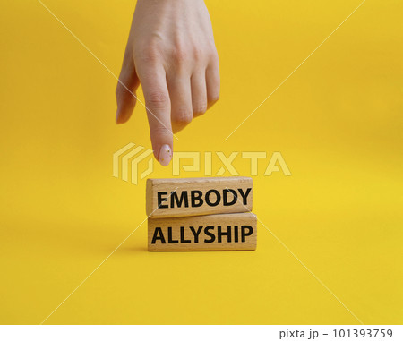 Embody Allyship symbol. Concept word Embody Allyship on wooden blocks. Beautiful blue background. Businessman hand. Business and Embody Allyship concept. Copy space 101393759