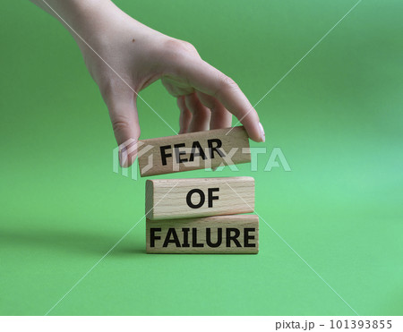 Fear of failure symbol. Concept words Fear of failure on wooden blocks. Beautiful green background. Businessman hand. Business and Fear of failure concept. Copy space. Fear of failure symbol. Concept words Fear of failure on wooden blocks. Beautiful green background. Businessman hand. Business and Fear of failure concept. Copy space. 101393855