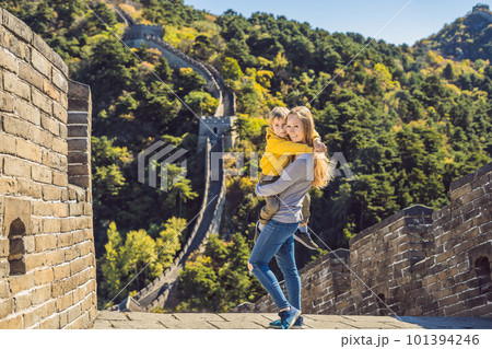 Happy cheerful joyful tourists mom and son at Great Wall of China having fun on travel smiling laughing and dancing during vacation trip in Asia. Chinese destination. Travel with children in China Happy cheerful joyful tourists mom and son at Great Wall of China having fun on travel smiling laughing and dancing during vacation trip in Asia. Chinese destination. Travel with children in China 101394246