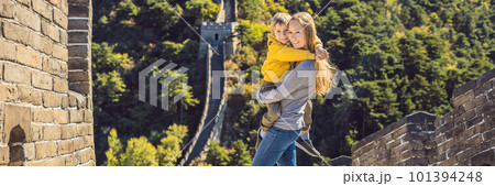 Happy cheerful joyful tourists mom and son at Great Wall of China having fun on travel smiling laughing and dancing during vacation trip in Asia. Chinese destination. Travel with children in China Happy cheerful joyful tourists mom and son at Great Wall of China having fun on travel smiling laughing and dancing during vacation trip in Asia. Chinese destination. Travel with children in China 101394248
