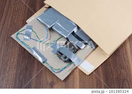 Mail bomb IED. Hand made Improvised Explosive Device with plastic explosive C-4 and cell phone module in envelope Mail bomb IED. Hand made Improvised Explosive Device with plastic explosive C-4 and cell phone module in envelope 101395324