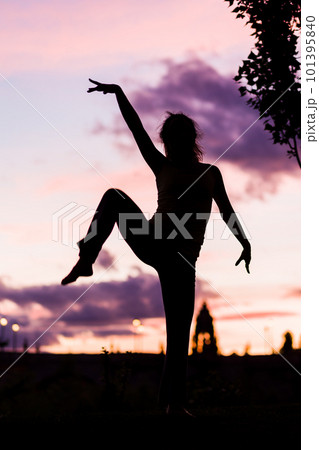 silhouette from a ballet dancer during the dusk or sunset happy positive motion with music  101395840