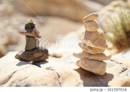 Pyramid stones balance on the sand rock. The object is in focus, the background is blurred Pyramid stones balance on the sand rock. The object is in focus, the background is blurred 101397016