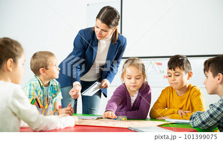 Kids and teacher playing educational board game Kids and teacher playing educational board game 101399075