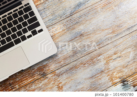 Laptop computer on wood table top view 101400780