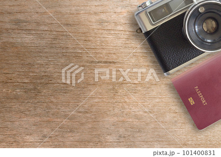 Vintage Camera and Passport on Wooden Background Vintage Camera and Passport on Wooden Background 101400831