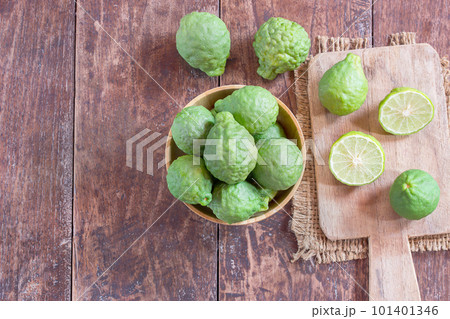 fresh bergamot and bergamot slice in wooden bowl 101401346