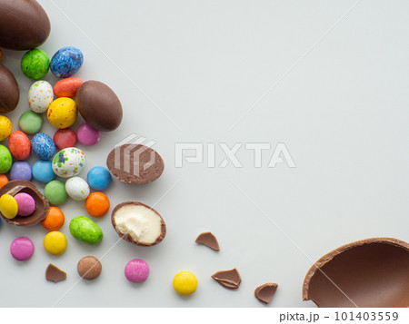 Colorful and chocolate easter eggs with sweet dragee on white background Colorful and chocolate easter eggs with sweet dragee on white background 101403559