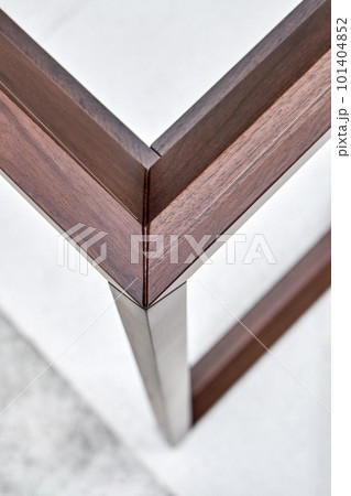 Wooden frame of bedside table made of solid walnut in workshop. Joinery angular joint of planks on dowels closeup Wooden frame of bedside table made of solid walnut in workshop. Joinery angular joint of planks on dowels closeup 101404852