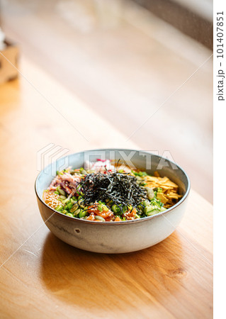 Portion of poke bowl dish on the table  101407851