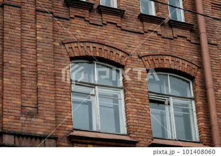 Old brick building with wooden windows. 101408060