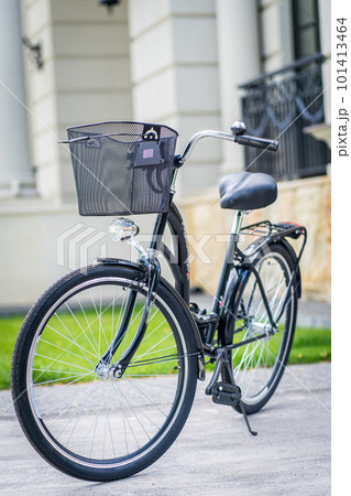 Metal bicycle basket. Vintage bike on the street as background. 101413464