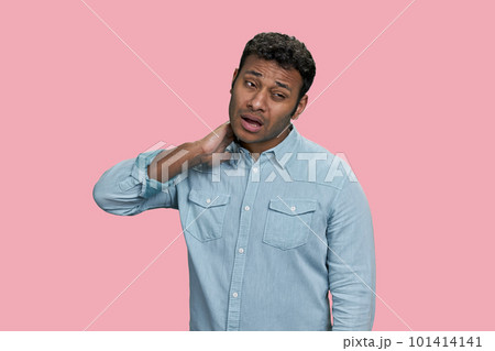 Portrait of indian man suffering from neckache. Isolated on pink background. Portrait of indian man suffering from neckache. Isolated on pink background. 101414141