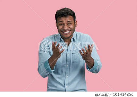 Young arab man laughing with teeth at something ridiculous. Isolated on pink background. 101414356