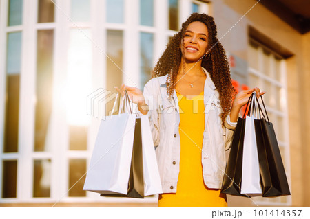 Young woman with shopping bags walking on street. , Sale concept. 101414357