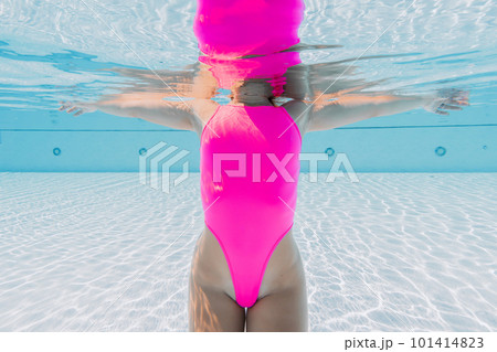 Sexy woman with perfect body in pink swimwear in pool. Underwater view Sexy woman with perfect body in pink swimwear in pool. Underwater view 101414823