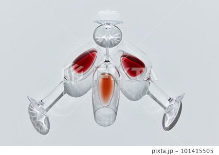 Art of liquid. Three glasses filled with delicious wine, lying against white background. Traditional taste 101415505