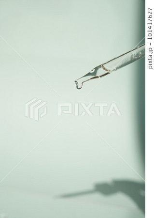 Natural medicine, cosmetic research. The concept of skin care and its analysis. Dermatology. With space to copy. Laboratory pipette with a drop of serum, oil, cosmetics. High quality photo 101417627