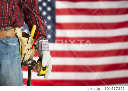 Laborer in gloves and toolbelt with measure on us flag background labor day mockup 101417891