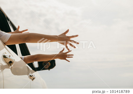 Father, mother and children raise hand wave goodbye, People having fun on road trip, vacation holiday, Happy family sitting in car waving hands travel outside car windows going to beach for travel Father, mother and children raise hand wave goodbye, People having fun on road trip, vacation holiday, Happy family sitting in car waving hands travel outside car windows going to beach for travel 101418789