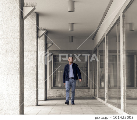 Confident business man standing in the city, looking and dreaming of future business success. Business vision. Leadership and successful conceptual strategy Confident business man standing in the city, looking and dreaming of future business success. Business vision. Leadership and successful conceptual strategy 101422003