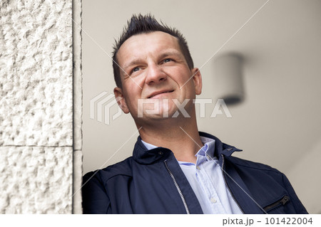 Confident business man standing in the city, looking and dreaming of future business success. Business vision. Leadership and successful conceptual strategy Confident business man standing in the city, looking and dreaming of future business success. Business vision. Leadership and successful conceptual strategy 101422004