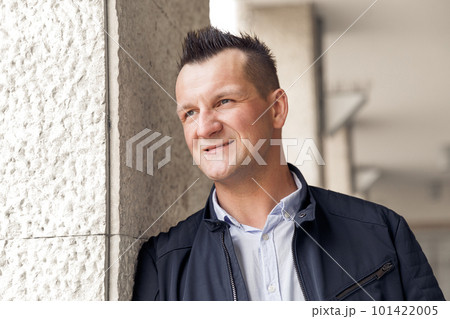 Confident business man standing in the city, looking and dreaming of future business success. Business vision. Leadership and successful conceptual strategy Confident business man standing in the city, looking and dreaming of future business success. Business vision. Leadership and successful conceptual strategy 101422005