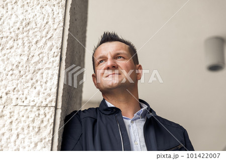 Confident business man standing in the city, looking and dreaming of future business success. Business vision. Leadership and successful conceptual strategy Confident business man standing in the city, looking and dreaming of future business success. Business vision. Leadership and successful conceptual strategy 101422007