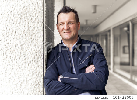 Confident business man standing in the city, looking and dreaming of future business success. Business vision. Leadership and successful conceptual strategy Confident business man standing in the city, looking and dreaming of future business success. Business vision. Leadership and successful conceptual strategy 101422009