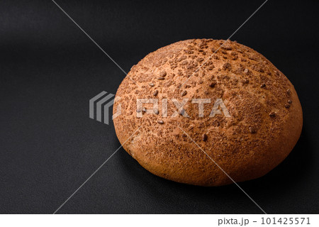 Fresh crispy brown bread with sesame seeds and spices Fresh crispy brown bread with sesame seeds and spices 101425571