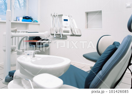 Close-up of dental equipment in dentistry clinic. Workplace and tools of dentists. Dental chair and surgical instruments Close-up of dental equipment in dentistry clinic. Workplace and tools of dentists. Dental chair and surgical instruments 101426085