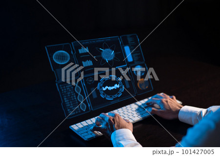 Caucasian man sits in the dark in front of a virtual menu. Close-up of male hands on the keyboard. Caucasian man sits in the dark in front of a virtual menu. Close-up of male hands on the keyboard. 101427005