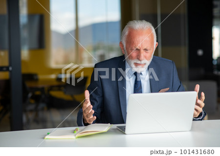 Handsome smiling senior man while sitting at his cozy workplace with laptop at home, retired male chatting with friends in social media, Handsome smiling senior man while sitting at his cozy workplace with laptop at home, retired male chatting with friends in social media, 101431680