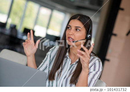 Brunette Lady Video Calling On Laptop Wearing Headphones Smiling And Waving Hand To Webcam Communicating Online Brunette Lady Video Calling On Laptop Wearing Headphones Smiling And Waving Hand To Webcam Communicating Online 101431732