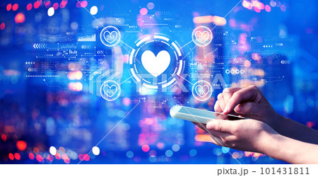 Get more likes concept with person using a smartphone at night Get more likes concept with person using a smartphone at night 101431811