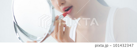 Beautiful young asian woman applying lipstick red on mouth. Beautiful young asian woman applying lipstick red on mouth. 101432347